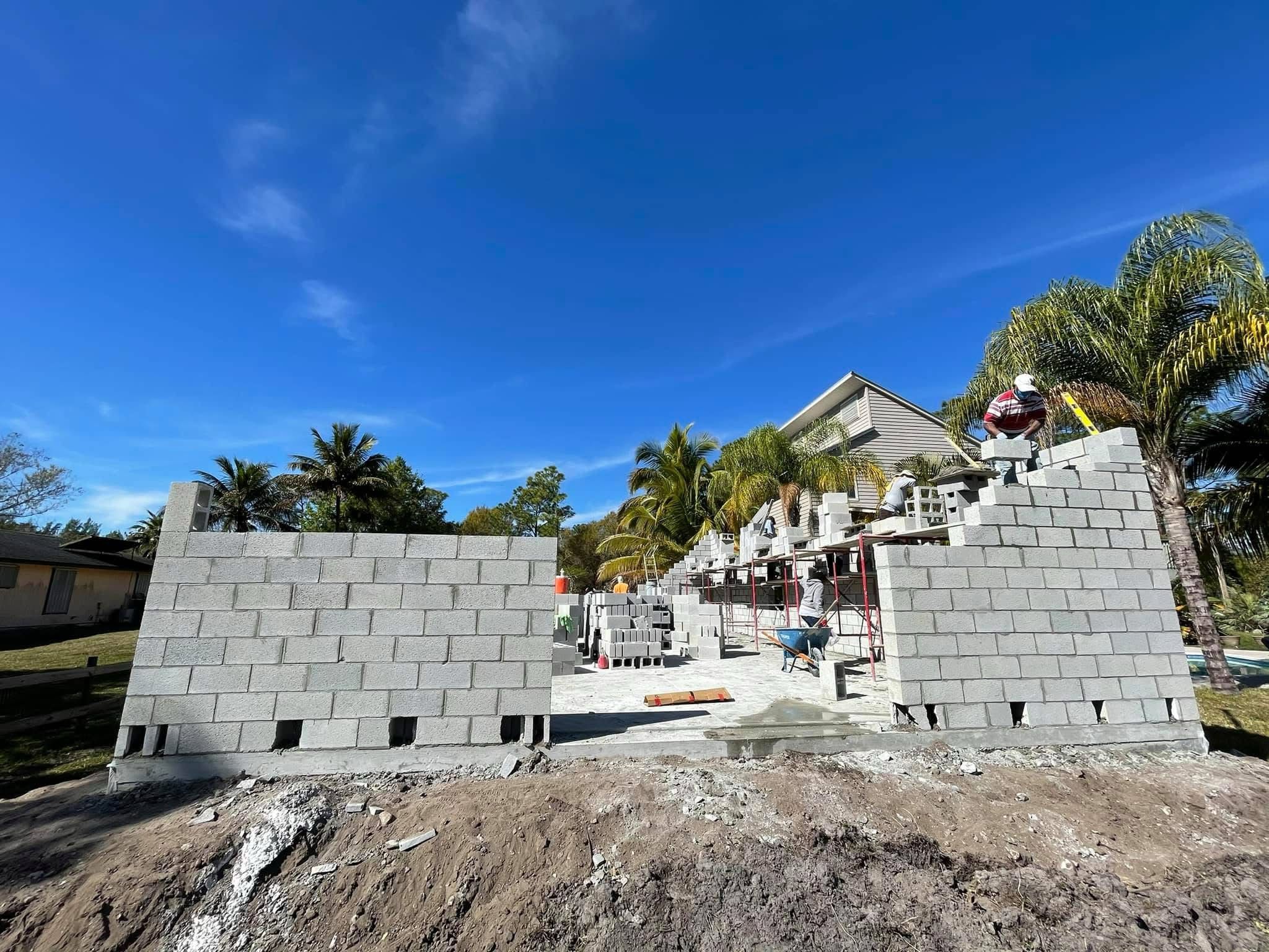 Masons laying CMU block walls on a residential project in Palm Beach County
