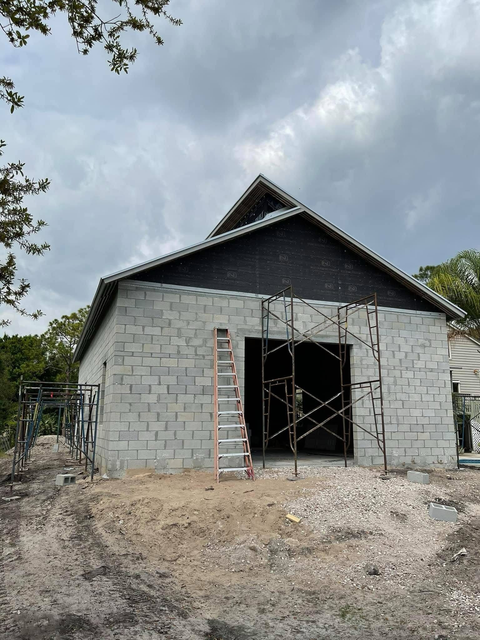Completed gable roof framing over a CMU shell in Palm Beach County